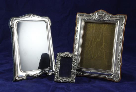 Three repousse silver rectangular photograph frames, largest 7.5in.